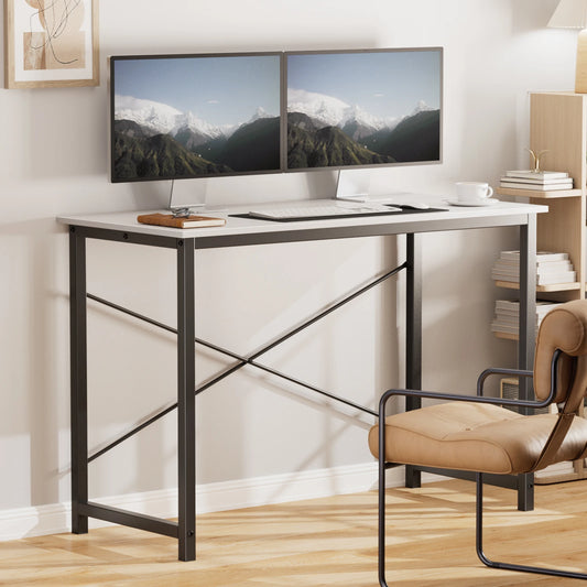 Modern office setup with a desk, chair, and dual monitors displaying mountain scenery.