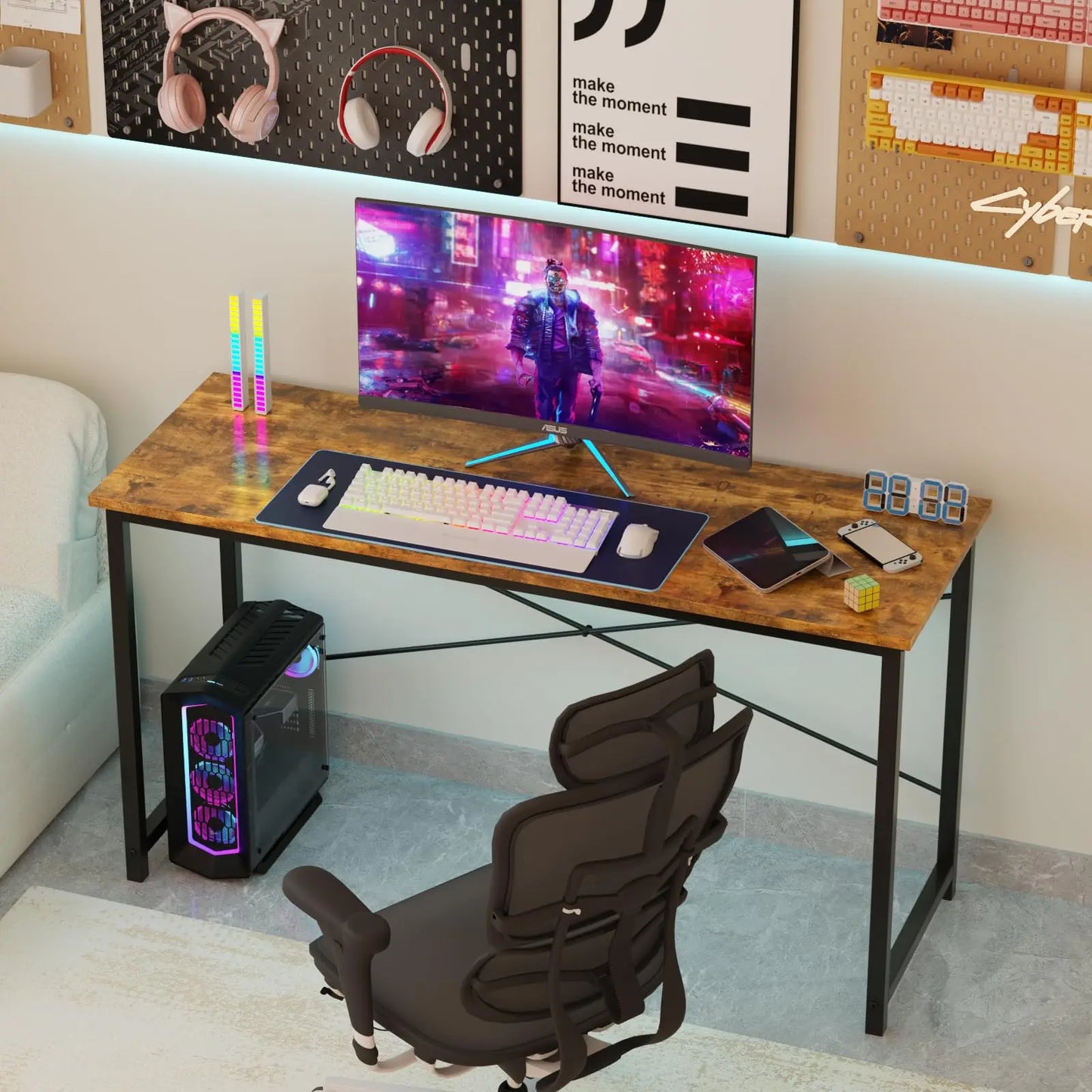 Gaming desk setup with computer monitor, keyboard, and chair in a room.