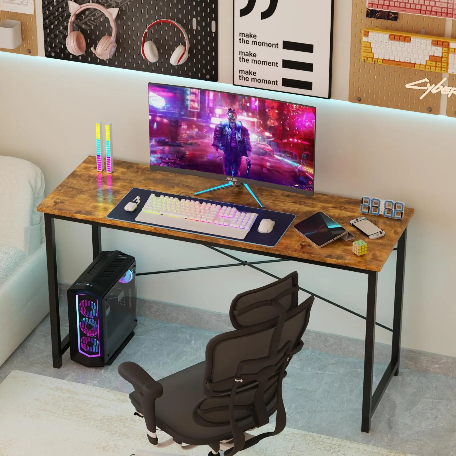 Gaming desk setup with computer monitor, keyboard, and chair in a room.