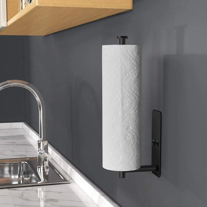 Roll of paper towels on a black wall-mounted holder in a kitchen.