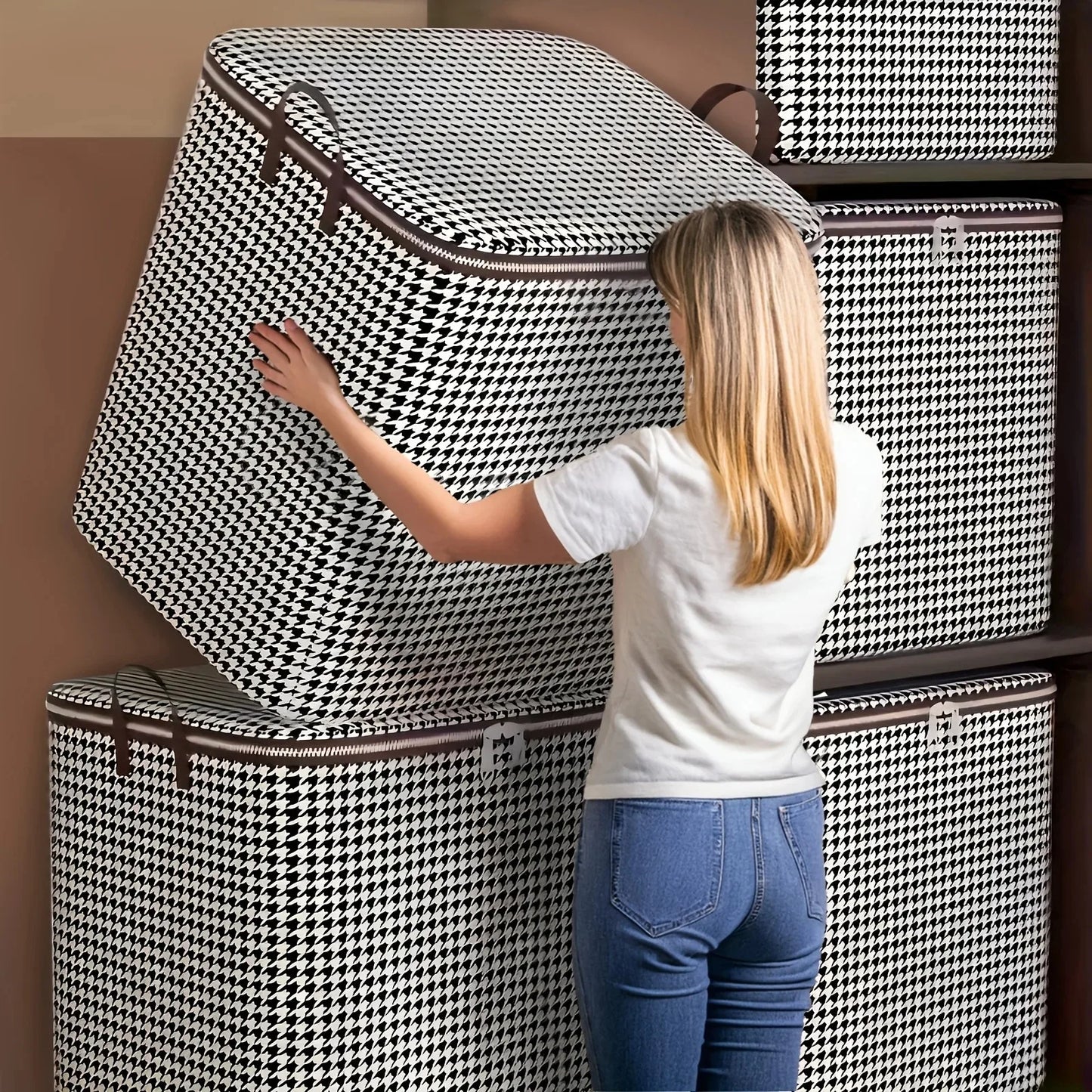 Woman arranging patterned storage boxes against a wall.